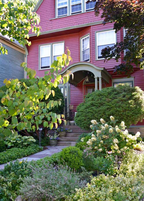 red house with colorful front landscape