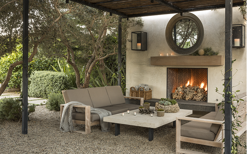 outdoor couches and coffee table in front of fireplace